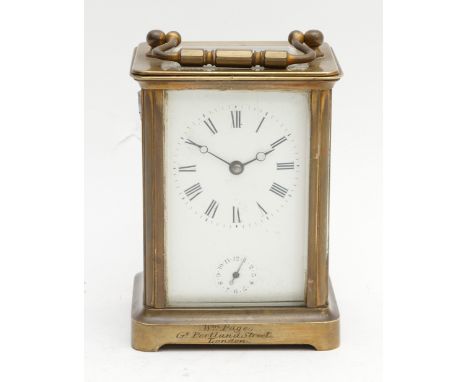 A 19th Century brass cased alarm carriage clock, with a white enamel dial, featuring black Roman Numerals, and a subsidiary a