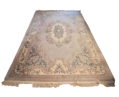 A Chinese wool rug, featuring mint green and pale pink floral decoration set against a cream and grey ground, 428cm x 305.