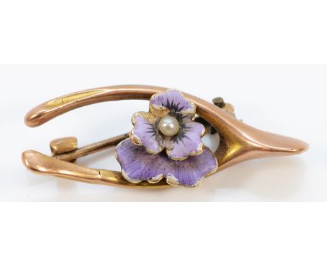 An Edwardian unmarked 9ct gold purple enamel and seed pearl wishbone shaped brooch, 30mm, 2.4g