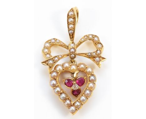 An unmarked Victorian 15ct gold seed pearl, ruby and diamond heart and bow pendant, 30mm, 3g