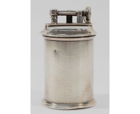 A silver petrol table lighter, by John Collard Vickery, Birmingham 1928, 9cm tall.