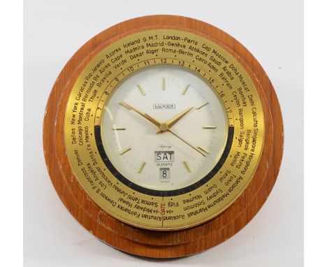 An Asprey Luxor 8 day world time desk alarm and date brass clock, reference 848, with 66 countries to the rotating bezel, dia