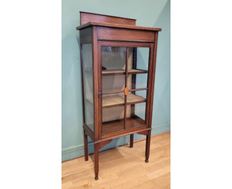 An Edwardian mahogany inlaid display cabinet, having single beaded glazed door opening to fitted shelves, raised on square ta