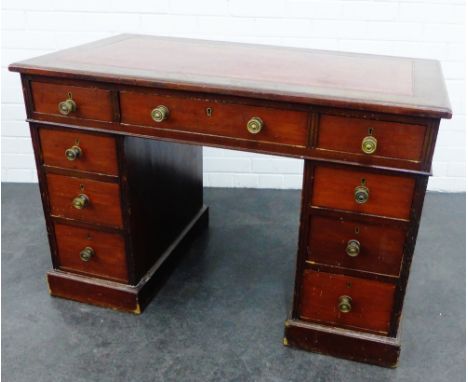 19th century mahogany desk, the rectangular top with an inset red leather skivver, over an arrangement of nine drawers, 74 x 