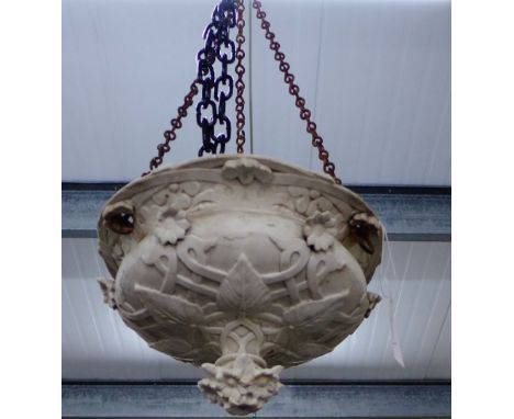 A white stoneware ceiling light shade, with moulded leaf and flower pattern
