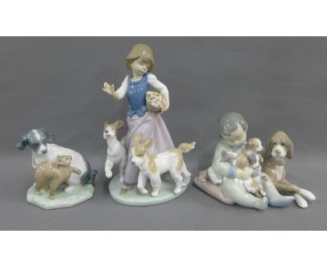 Two Lladro figures of Children with Dogs and a Nao figure of a Dog and Cat, (3) 