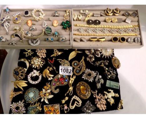 Two trays of rings, brooches, cufflinks and bracelets, and a tray of forty five brooches. UK P&amp;P Group 2 (£20+VAT for the