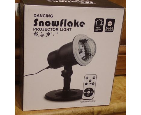 New old stock dancing snowflake projector light for outdoor and indoor use with remote, boxed, working at lotting. Not availa