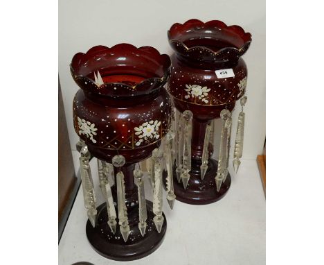 A pair of Victorian cranberry glass lustres, with enamel floral decoration and gilt detailing, crystal lustre drops, each 37c