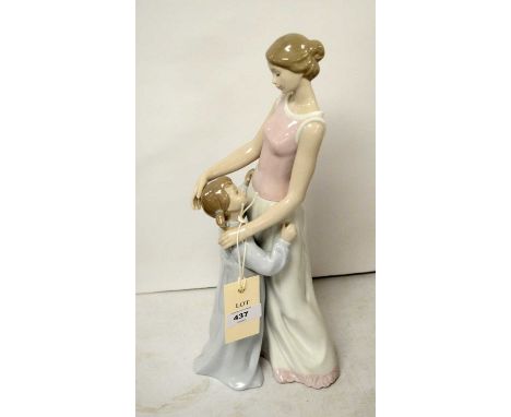 A Lladro figure group of a mother and child, modelled embracing, 36cms high.
