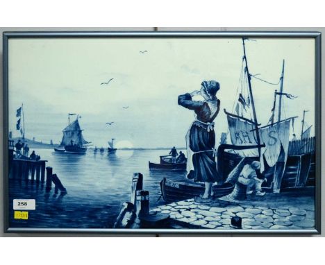 A Delft blue and white maritime wall tile, of rectangular form, illustrating a lady by the port, by V &amp; B M, No. 5174. 31