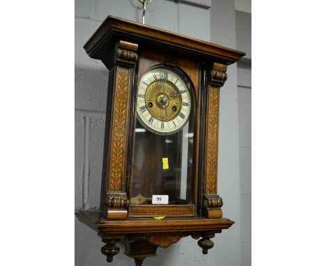 An ornate Vienna style wall clock, in architectural mahogany case with penwork floral decoration, 47cms high.