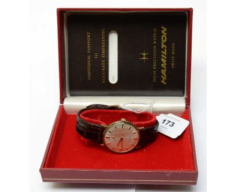 A 9ct yellow gold cased wristwatch by Hamilton, St Jones, fitted manual wind movement, with 'passport' and box. 