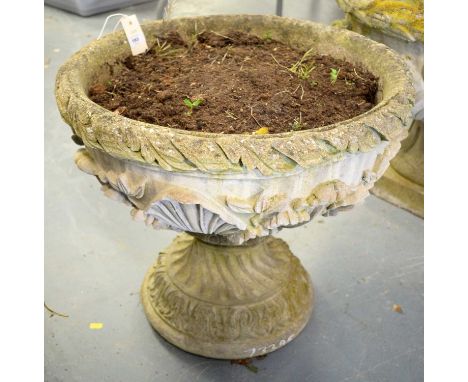 A stone composite garden planter, decorated with foliate designs, raised on a knopped stem terminating in a circular foot, 54