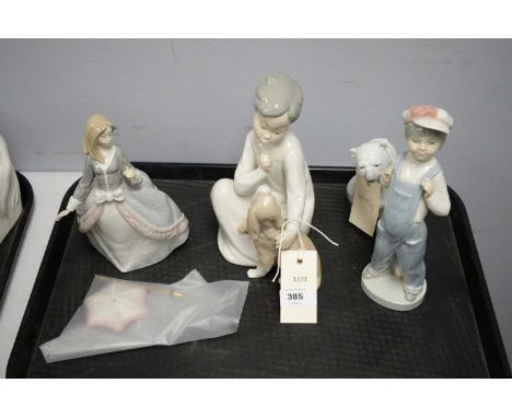 A collection of Lladro figures, including: polar bear; boy with dog; lady with umbrella; and another, the tallest 21.5cms hig