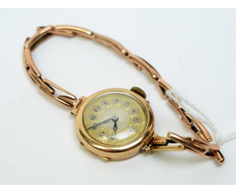 A 9ct yellow gold cased cocktail watch, fitted manual wind movement and arabic silvered dial, 16.4g gross. 