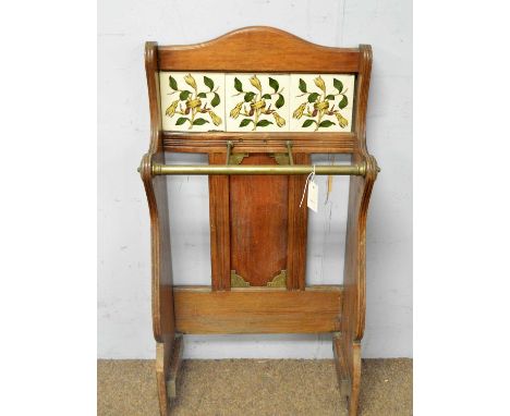 An Edwardian walnut and brass tile back stick stand.