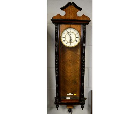 A walnut and ebonised Vienna wall timepiece, the brass and white enamel dial with Roman numerals in black, subsidiary seconds