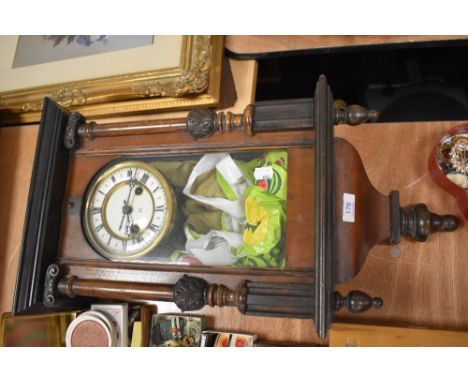 A late Victorian Vienna styled wall clock having an enamel dial with a veneer and carved case.