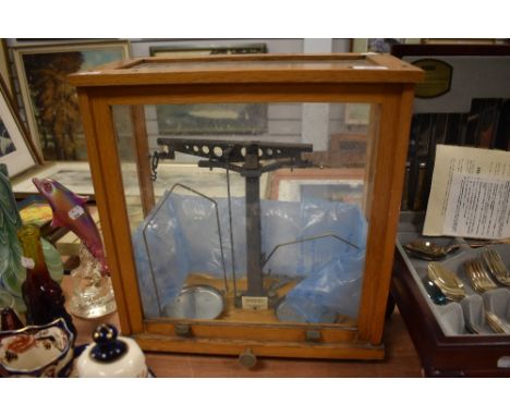 A set of Phillip Harris apothecary or chemist scales in a fitted oak case.