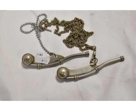 Two 20th century bosun's whistles both bearing a military arrow mark.