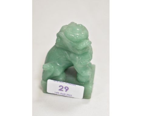 A 20th century Chinese Dog of Fo carved in an apple green jade. 7cm tall