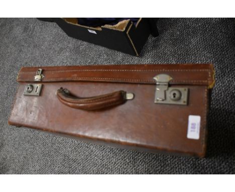 An early 20th century leather bound travel trunk or suitcase.