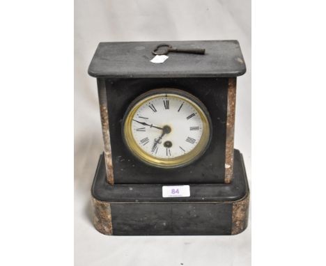A Victorian slate and red marble mantel clock with key.