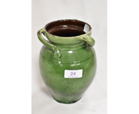 An Arts and Crafts period studio pottery vase in an olive green lustre glaze with three sweeping handles in a Brannam style, 