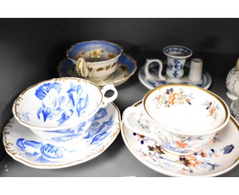 Three Victorian porcelain tea cup and saucers sets including Grainger Worcester also a German porcelain chamber stick.