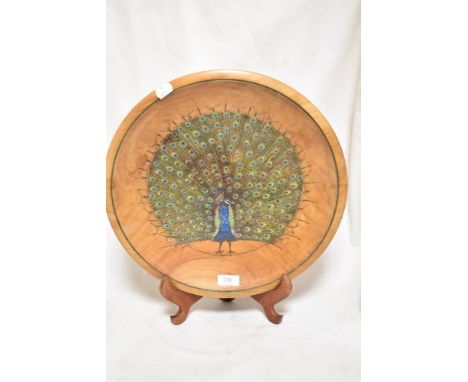 A vintage Cherry wood bowl decorated with a Peacock design, signed Wilkinson. 37cm wide.