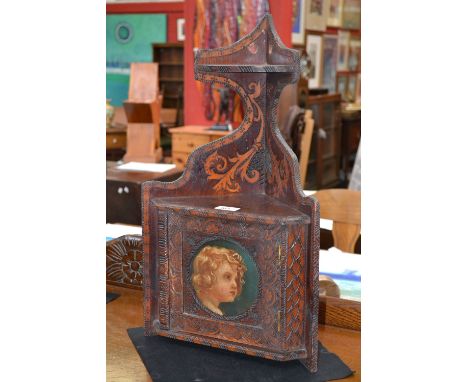 An early 20th century corner cabinet, of small proportions, small cupboard with two shelves to top, the central circular pane