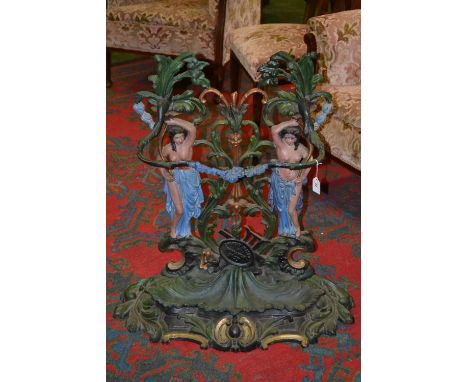 A decorative cast iron stick stand, cast as two scantily clad maidens amid foliage, cartouche cast with Corneau Alfred A Char