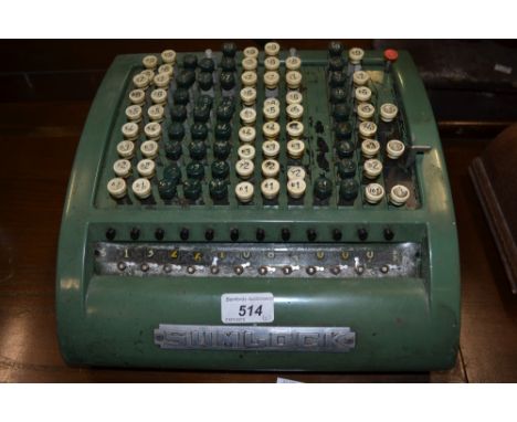 An interesting adding machine, by Sumlock; an Art Deco oak mantel clock twin winding holes, Arabic numerals, c.1930 (2)