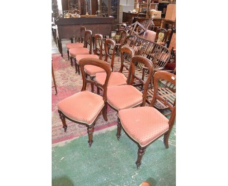 A set of eight Victorian mahogany balloon back dining chairs, retailed by Filmore & Sons, London, stuffed-over seats, turned 