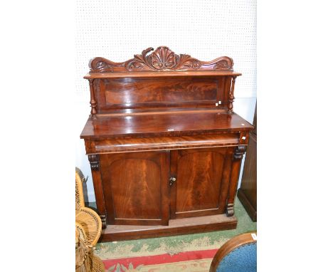 A mahogany chiffonier, cresting shell carved and scrolled gallery, single shelf with turned supports to top, long drawer over