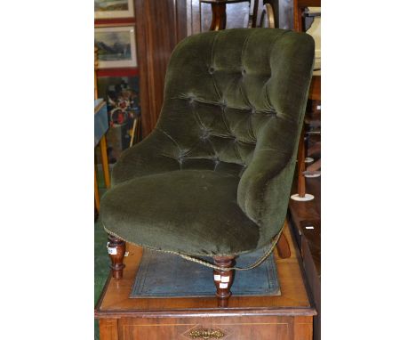 An early 20th century button back nursing chair.