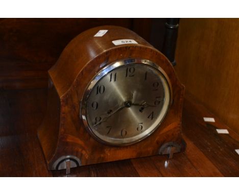 An Art Deco walnut and chrome mantel clock silvered dial, Arabic numerals, chrome feet, chiming eight day movement. 