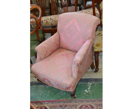 A Victorian nursing chair, mahogany legs, ceramic casters