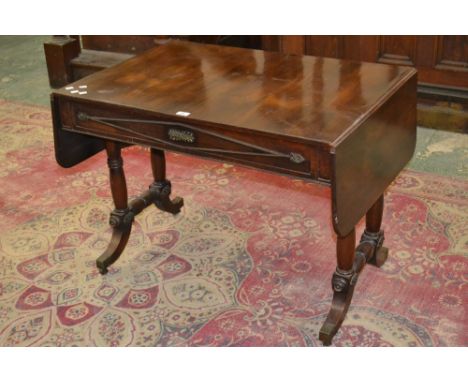 A Regency gilt mounted mahogany sofa table, two short drawers to frieze, turned supports and stretchers, sabre legs, brass ca