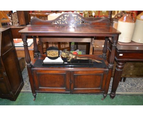 A William IV/early Victorian mahogany buffet, serpentine cresting pierced with leafy scrolls centred by a shield shaped carto