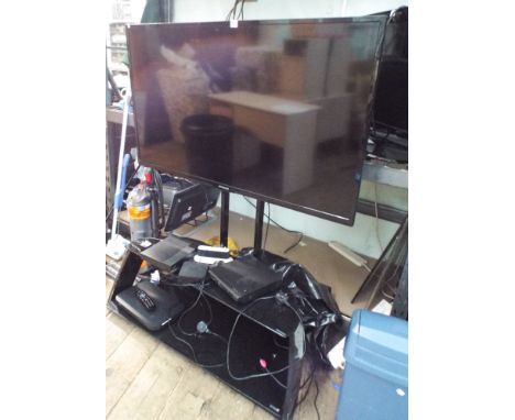Polaroid 50" digital LCD TV with Freeview etc. on a 2 tier glass stand with DVD player, Sky box etc. 