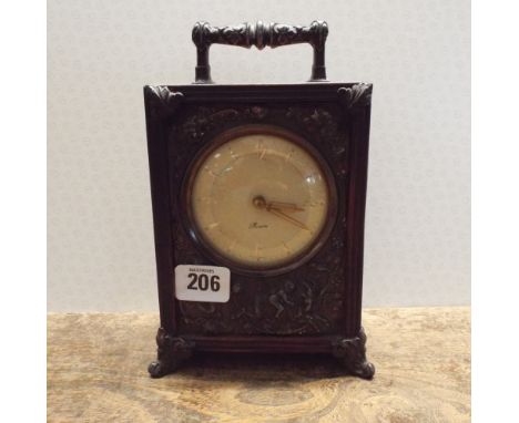 Mantel clock with carry handle in a mahogany case decorated with metal panel 