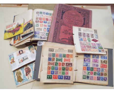 Collection of British and Foreign stamps together with four books of Brooke Bond tea stamps, an old world atlas and a book co