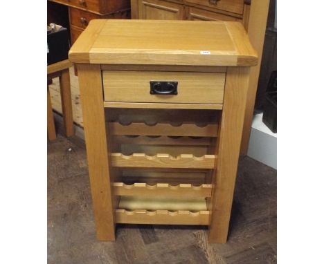 Heavy light oak wine cabinet with fitted drawer and side glass compartments 