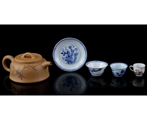Yixing earthenware teapot with decor of Chinese characters and bamboo, China 20th century, porcelain cup with blue landscape 