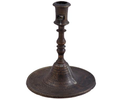 Bronze candlestick on round saucer-shaped base, France early 16th century17 cm high, base 14.5 cm diameter (restoration on ba