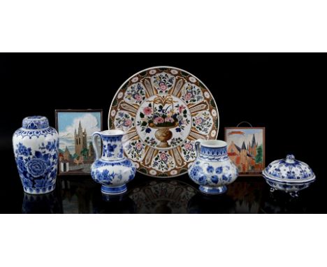 The Porceleyne Fles earthenware dish with polychrome floral decor, 33 cm diameter (hairlines and chips), 2 Porceleyne bottle 