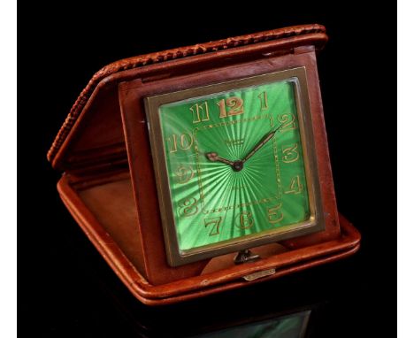 Swiss travel alarm clock, brand illegible, dial with green enameled decor in a leather case, 1960s, 11x11 cm