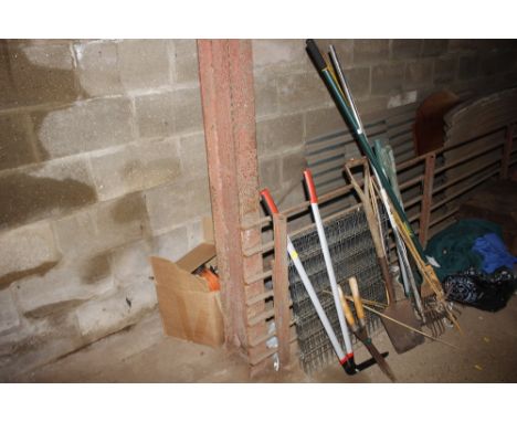 A quantity of long handled gardening tools, folding dog cage etc. 